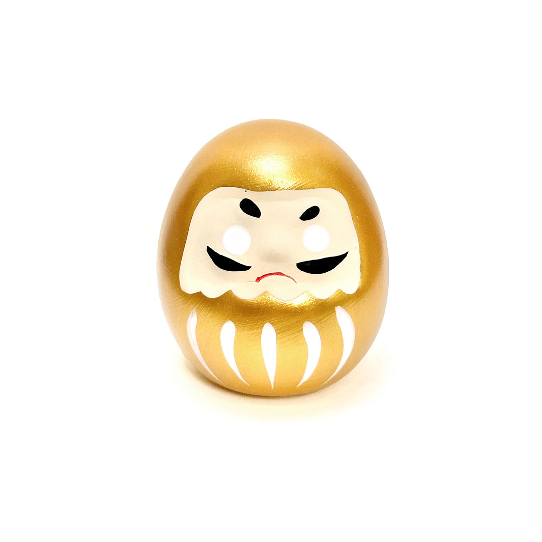 photo packshot d'un daruma doré en céramique