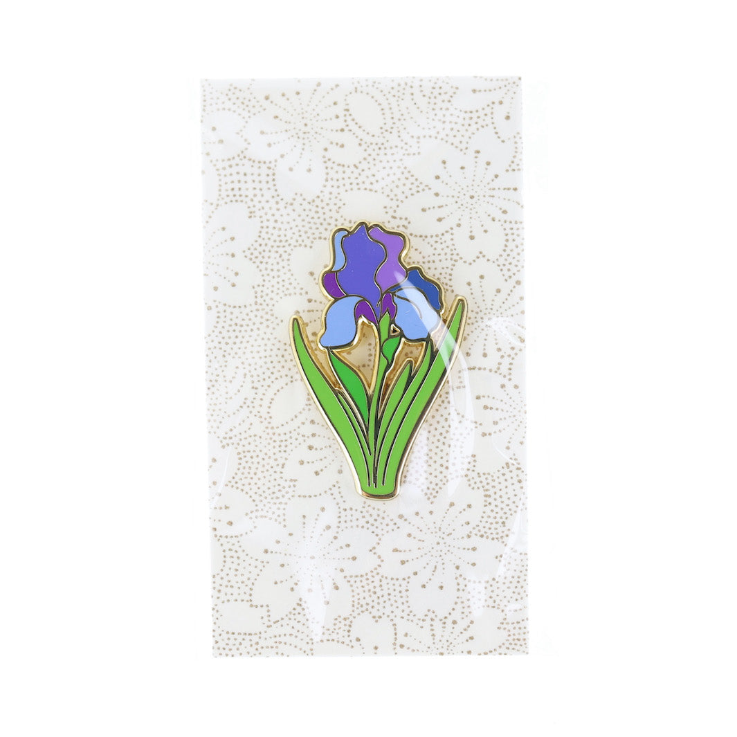 photo packshot du packaging du pin's en forme de fleurs d'iris bleue, violette et verte
