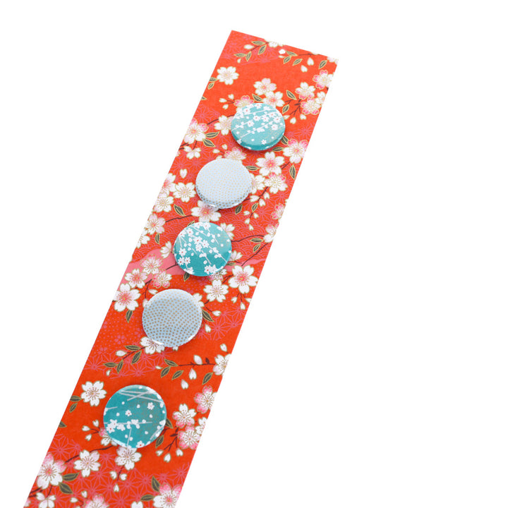 photo packshot avec une vue de biais du pêle-mêle tapissé du papier japonais aux motifs de fleurs de cerisier et de dessins variés blanc crème, rose clair et rouge orangé M385 adeline klam