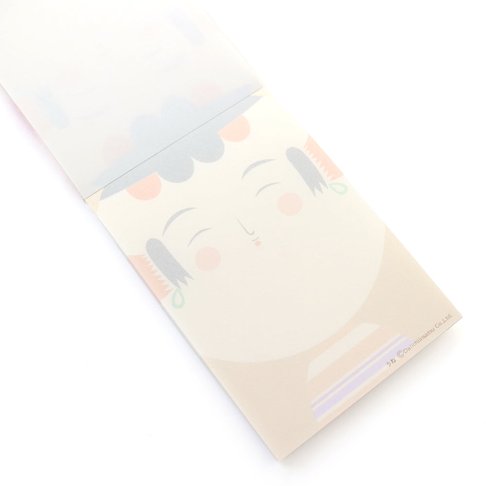 image packshot de biais de l'intérieur du bloc-notes de 60 feuilles aux motifs de kokeshi sur fond jaune