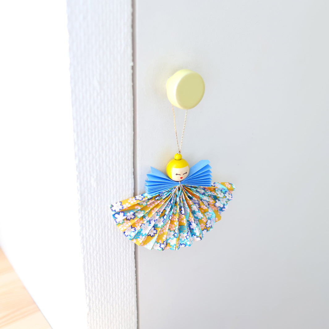photo packshot d'un ange suspendu du kit anges accordéon dans les tons jaune pâle, jaune moutarde, bleu pervenche, bleu marine et turquoise « horizon » adeline klam