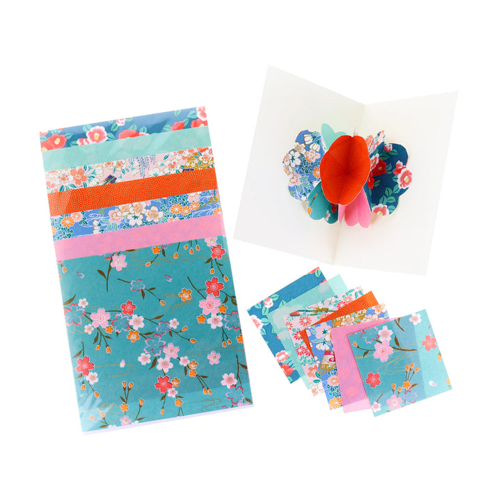 photo packshot d'une carte montée et des papiers japonais du kit 4 cartes pop-up dans les tons bleu turquoise, vert d'eau, roses et rouge orange « lagune » adeline klam