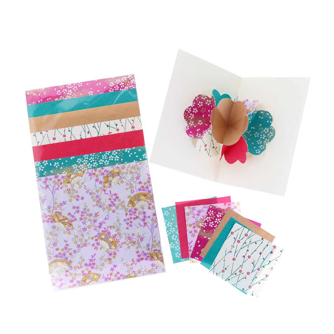 photo packshot d'une carte montée et des papiers japonais du kit 4 cartes pop-up dans les tons mauve, magenta, bleu canard et dorés « fluorite » adeline klam