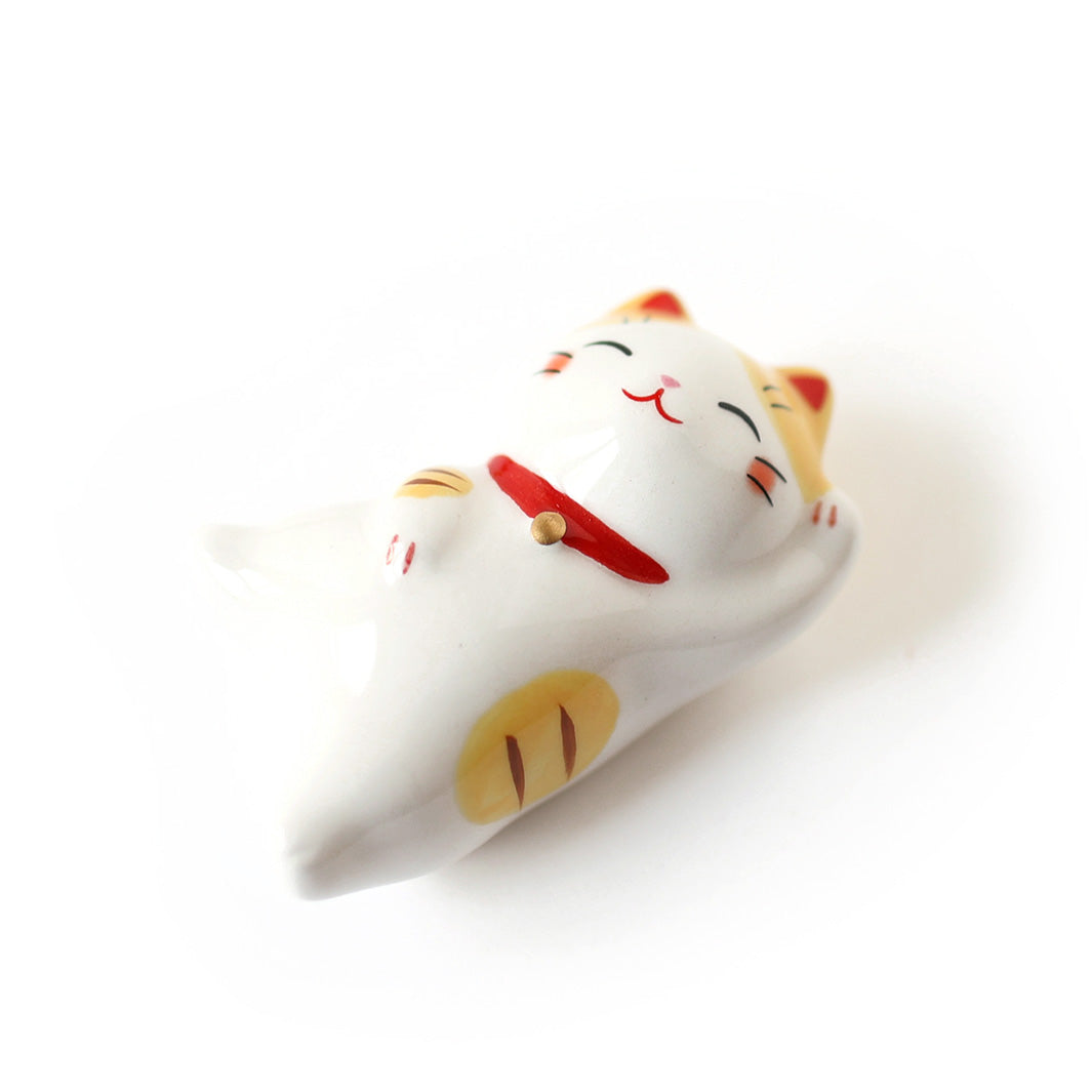 photo packshot d'un chat maneki-neko en céramique au pelage blanc tigré de jaune et de marron 