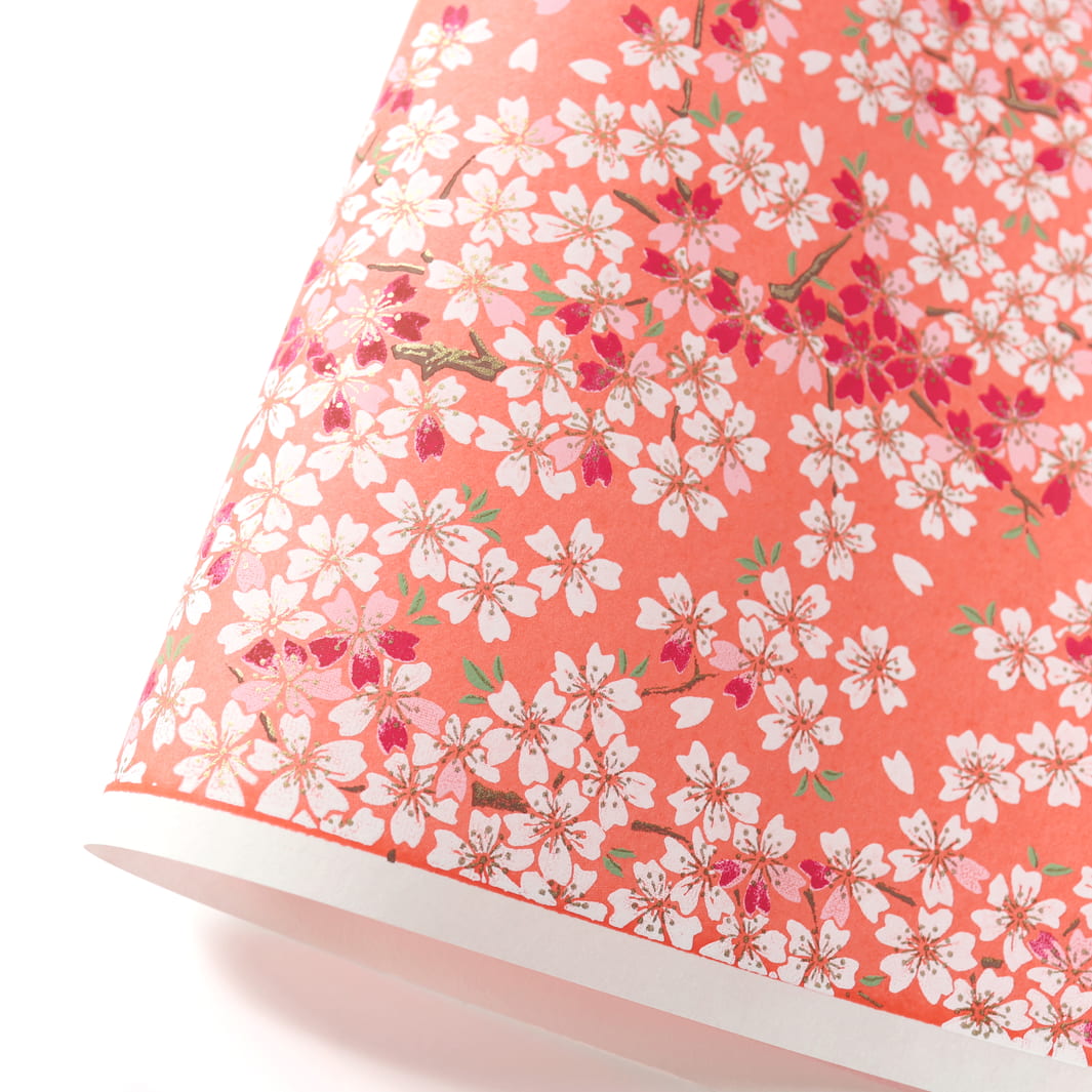 photo packshot d'une courbe de papier japonais yuzen chiyogami au motif de fleurs de cerisier dans les tons corail, rose pâle, rouge carmin et blancs adeline klam (M622)