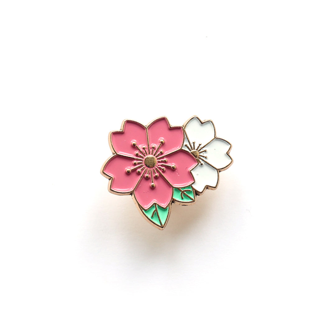 photo packshot du pin's en forme de duo de fleurs de cerisier roses et blanches aux feuillages vert clair