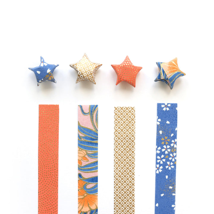 photo packshot des étoiles montées et des bandelettes de papiers japonais du kit étoiles en origami dans les tons corail, bleu pervenche, roses et dorés « william » adeline klam