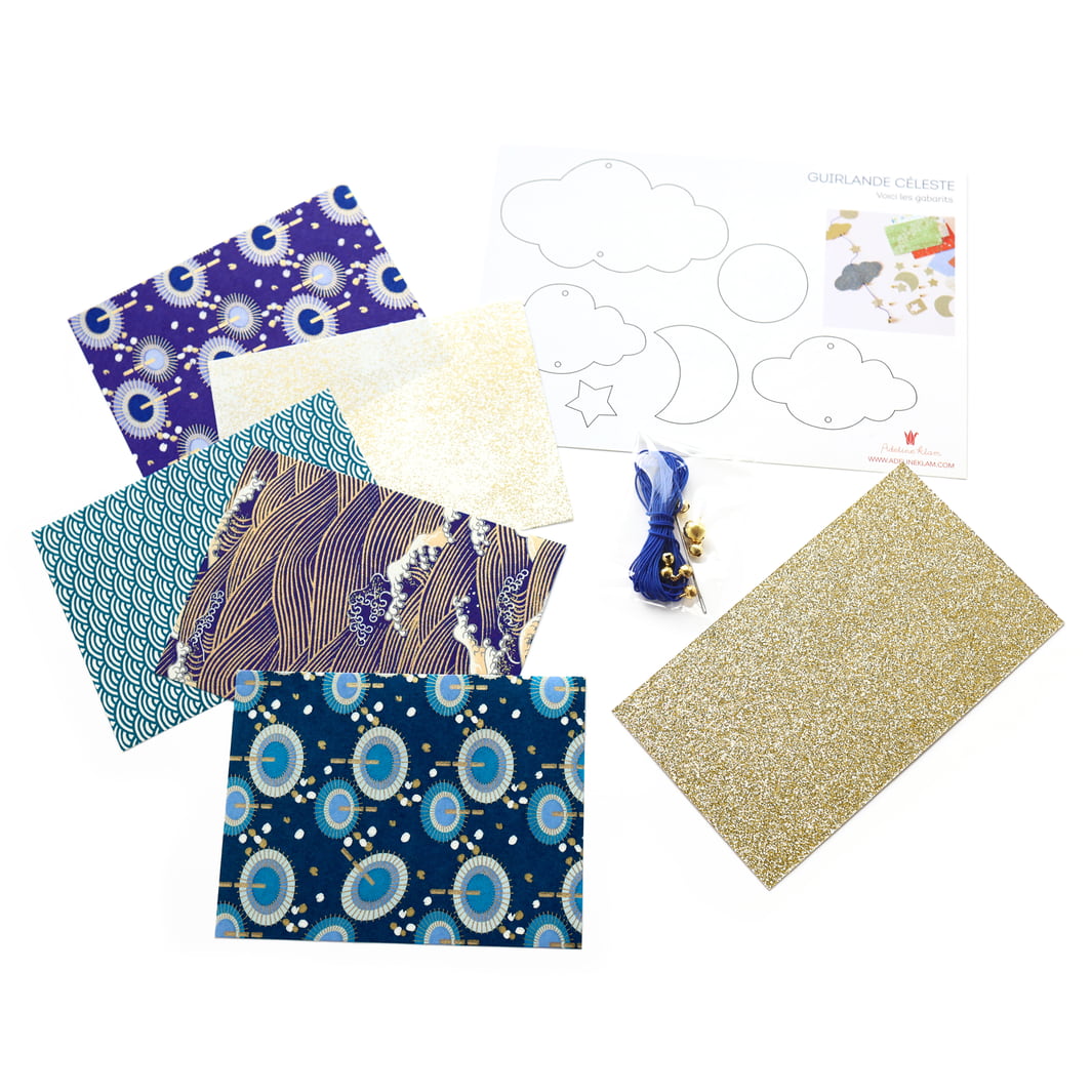 photo packshot des fournitures du kit guirlande de nuages « céleste » dans les tons bleu nuit et marine, blancs et dorés « cosmique » adeline klam
