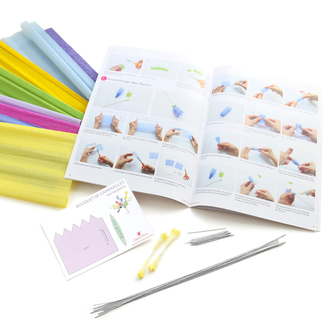 photo packshot du manuel ouvert et des fournitures du kit bouquet de campanules en crépon dans les tons bleu violet, bleu ciel, jaunes, ivoire, magenta et vert moyen adeline klam