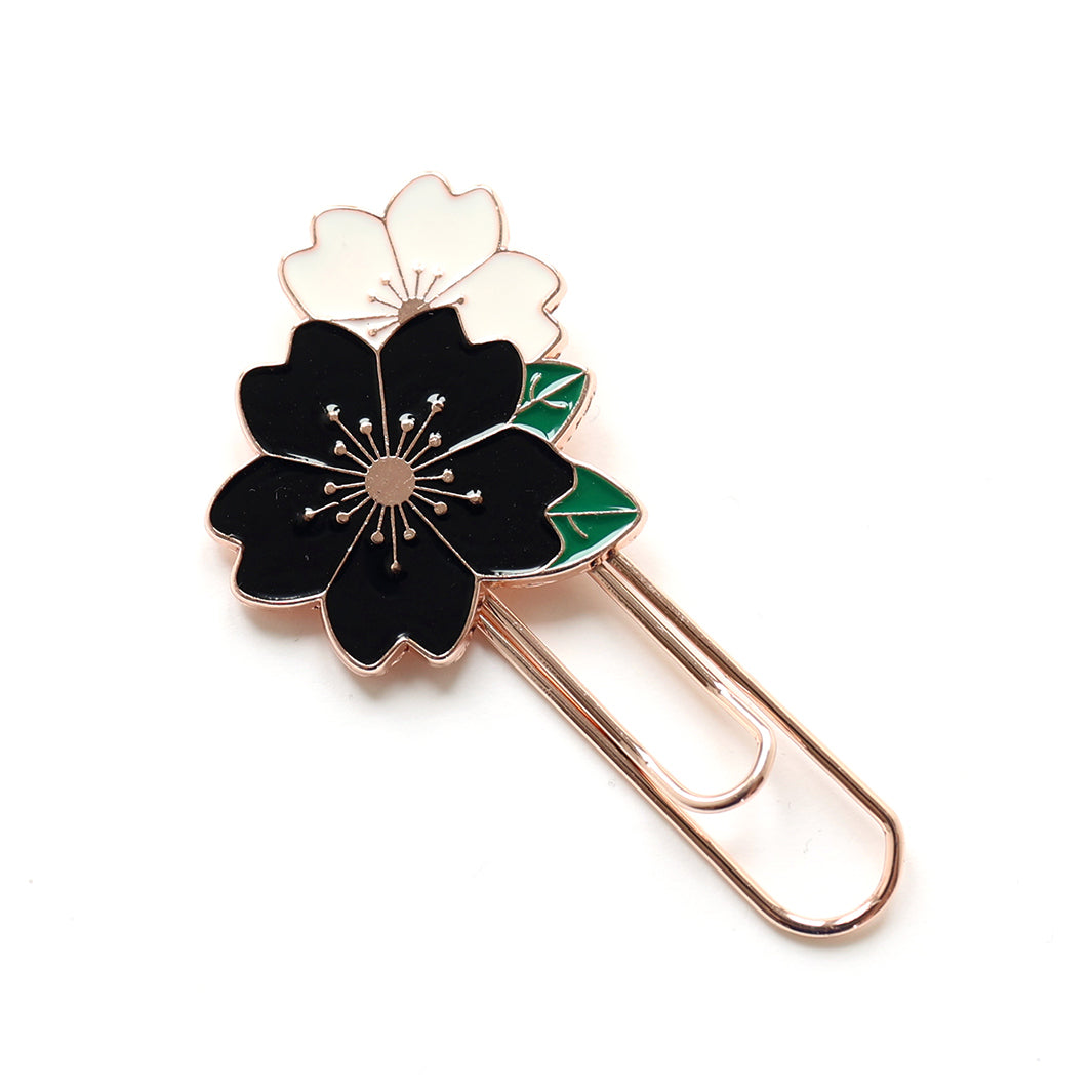 photo packshot du marque-page trombone or rose décoré de fleurs de cerisier noires et blanches aux feuillages verts