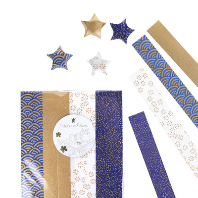 photo packshot du packaging et étoiles montées du kit étoiles en origami « céleste » dans les tons bleu nuit, dorés et blanc adeline klam