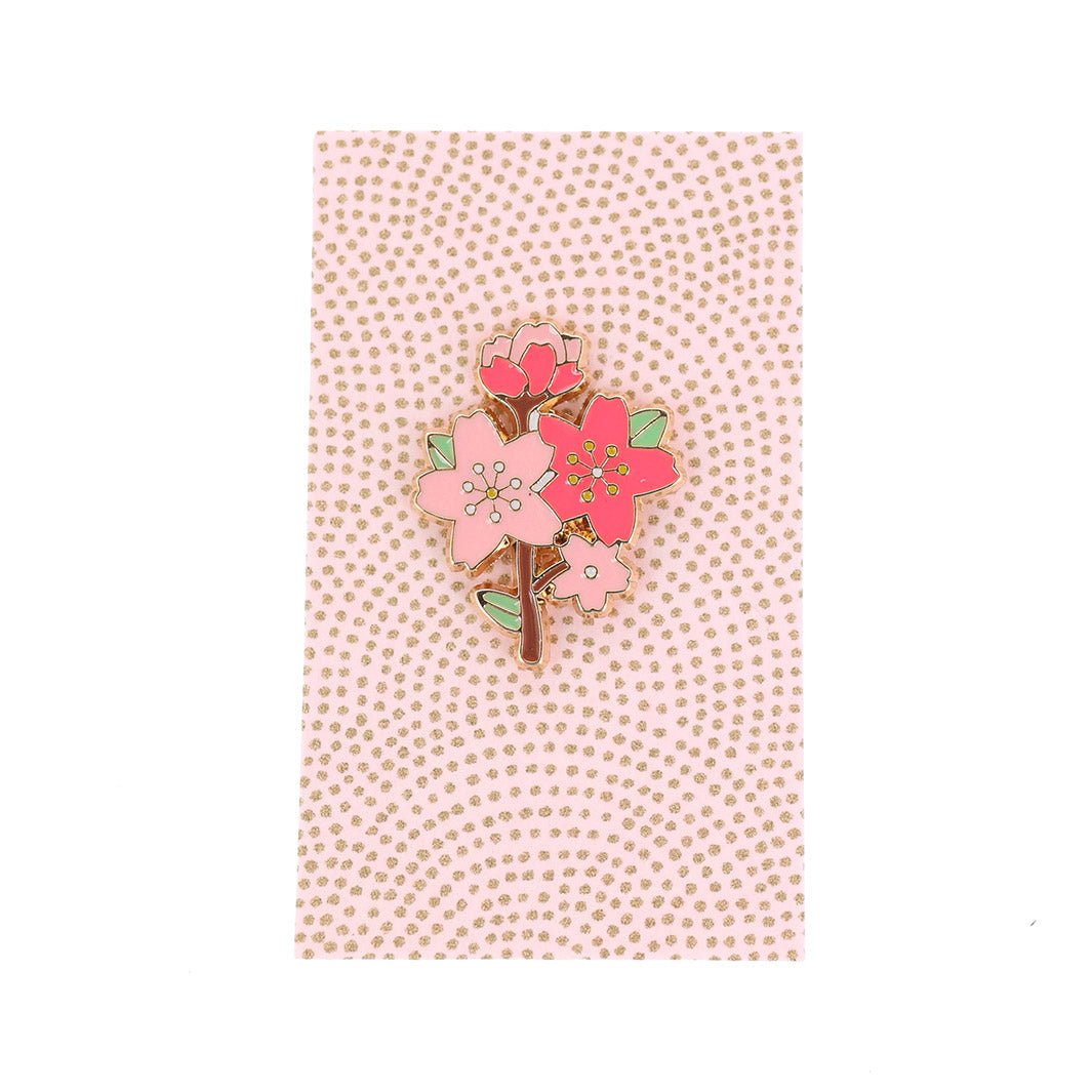 photo packshot du packaging du pin's en forme de branche de fleurs de cerisier rose, vert et marron