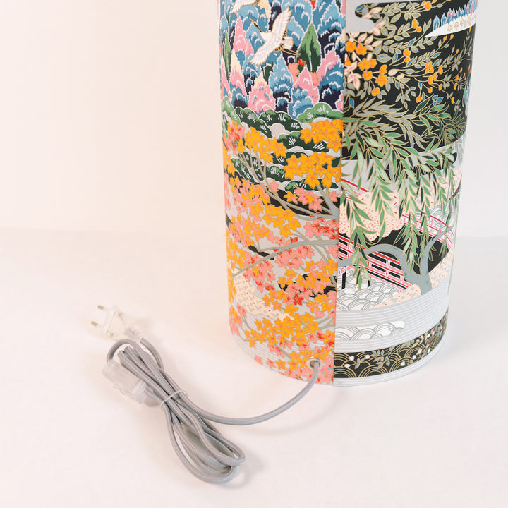 photo packshot avec une vue zoomée d'un détail du câble électrique gris d'une lampe à poser japonaise (taille xl) au motif de paysage japonais dans les tons bleus, verts, gris, noirs, orange et roses