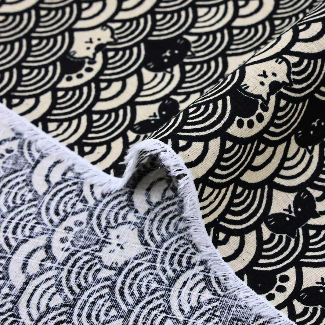 photo packshot zoomée d'un détail du tissu japonais aux motifs de vagues et de chats dans les tons noirs et beige T550