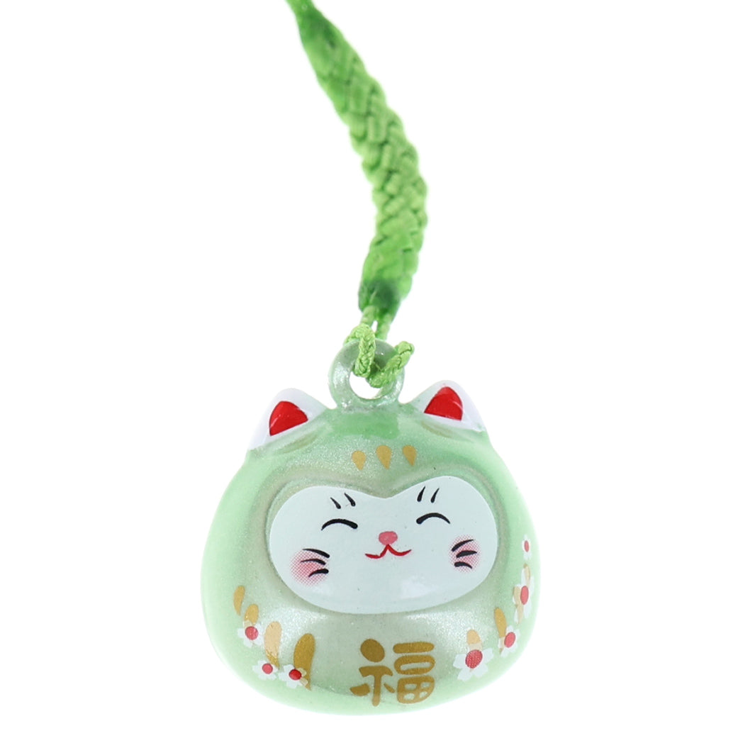 photo packshot zoomée d'un porte-clefs en forme de daruma et de chat de couleur vert clair nacré